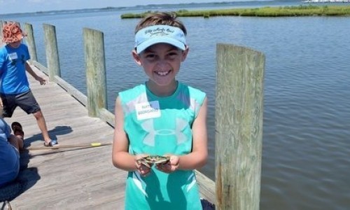 Fishing-Camp.jpg Young Boy Holding Blue Crab