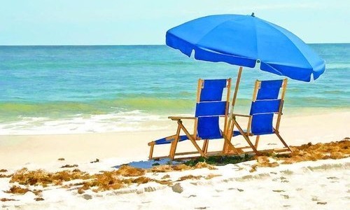rentals.jpg Two Blue Chairs and Umbrella on Beach